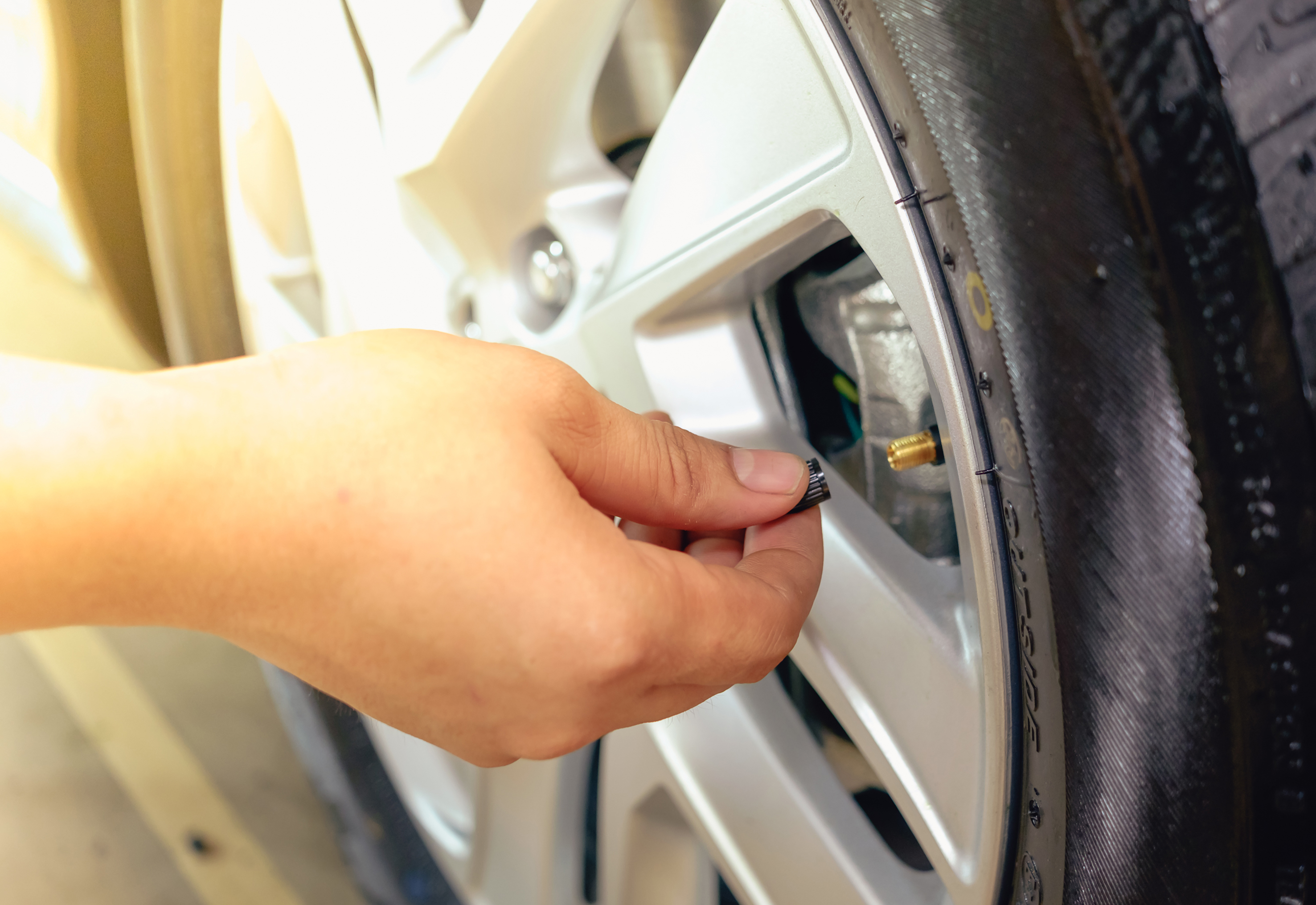 Hand removing a tire black. Check the tire air pressure. Hand removing a tire black. Check the tire air pressure.